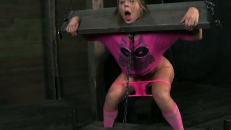 White skank Chastity Lynn is fixed in the pillory and teased