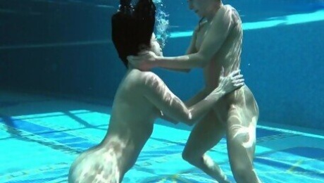 Two tight babes swimming naked together